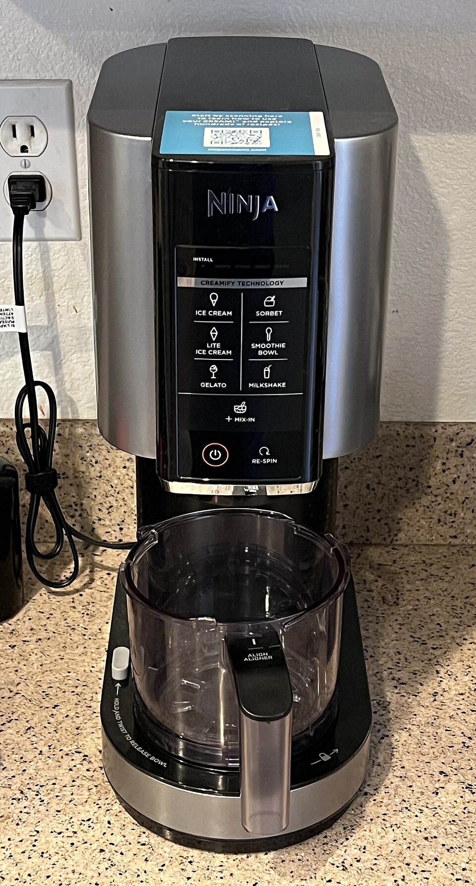 Ninja CREAMi ice cream maker in silver on a kitchen counter
