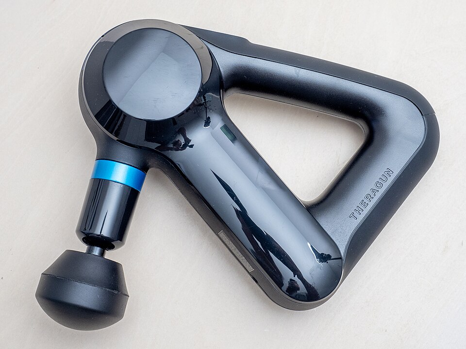 Theragun Mini 2nd Gen massage gun in black with attachments